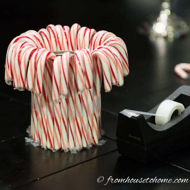 Scotch tape wrapped around candy canes on the outside of a tin can