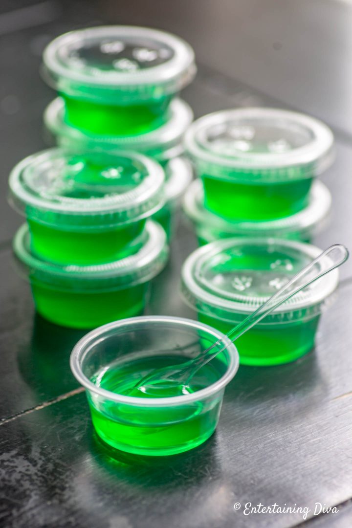Margarita jello shots in jello shot cups with tasting spoon