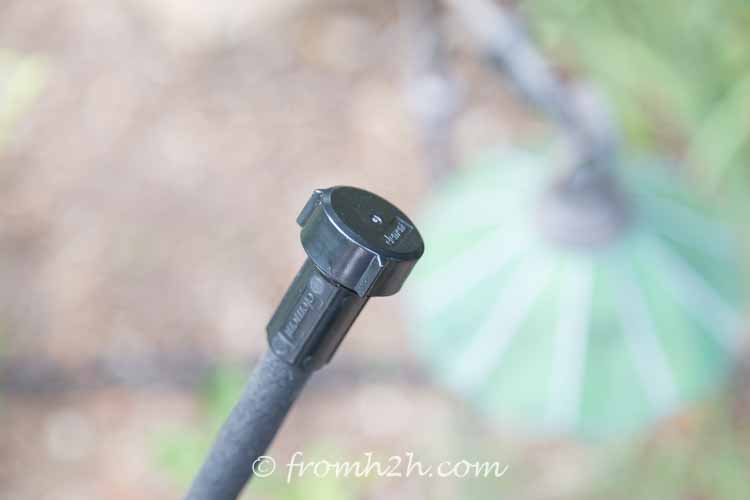 Soaker hose system end pushed onto the hose