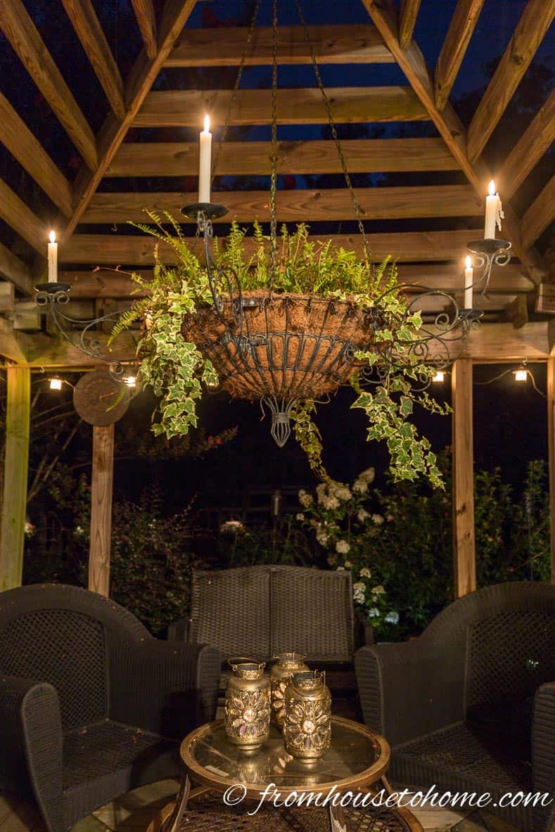 A gazebo with a candelabra in the middle and lights around the outside