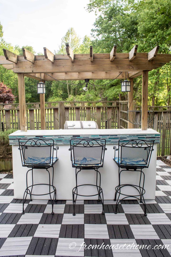 Outdoor bar with black and white checkered pattern deck tiles