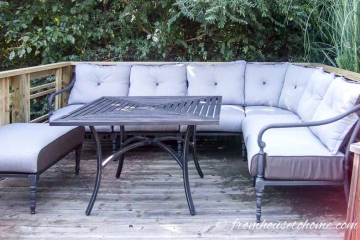 Outdoor sectional sofa on a deck with a square dining table