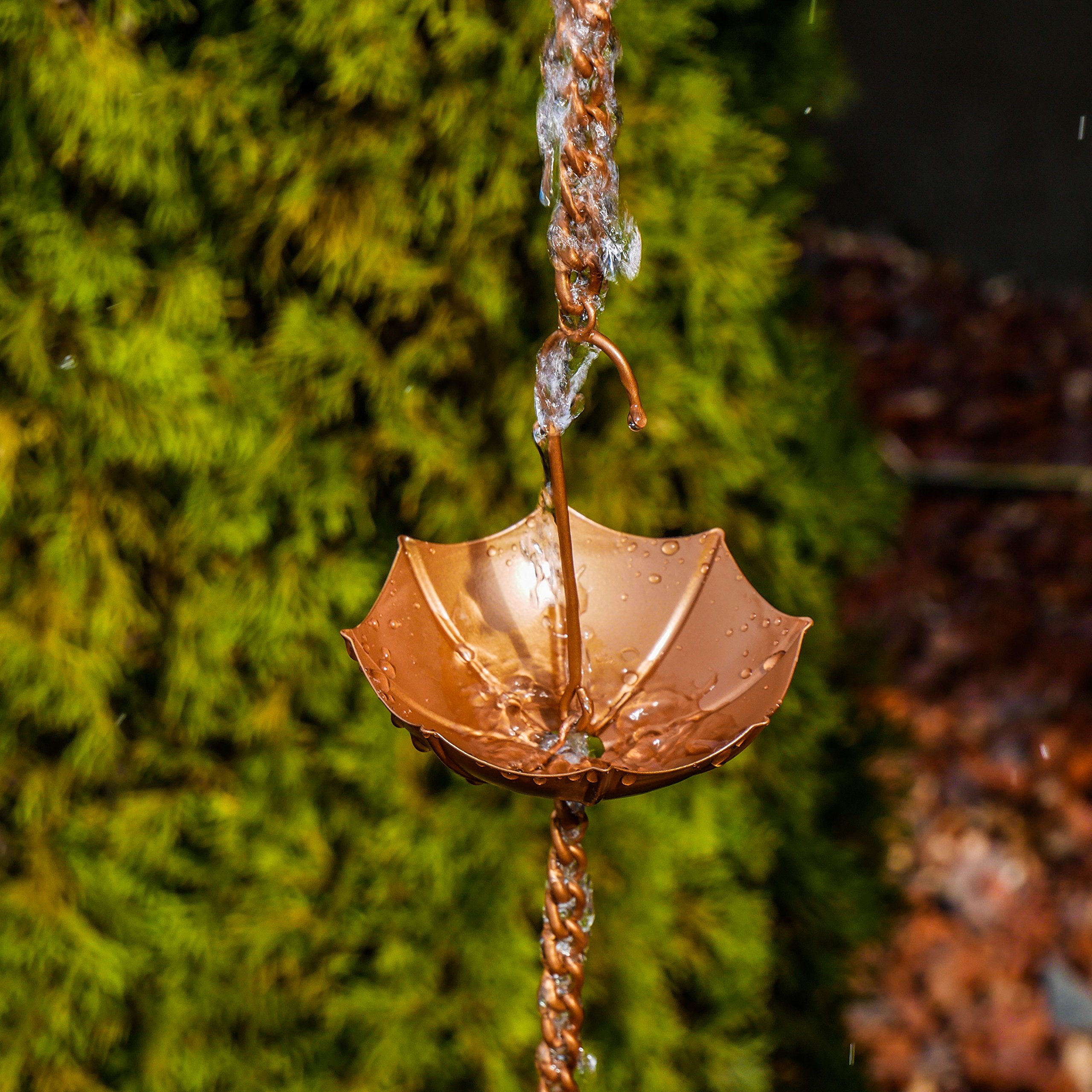 Umbrella rain chain with water running down it