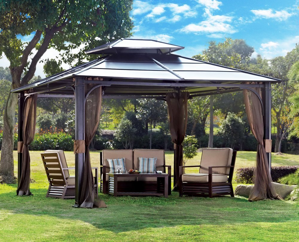 Metal outdoor gazebo over an outdoor furniture set in the middle of the yard