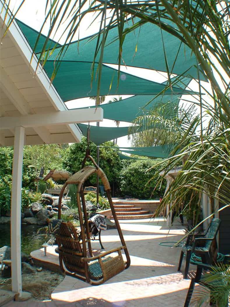 Multiple green shade sails over a walkway