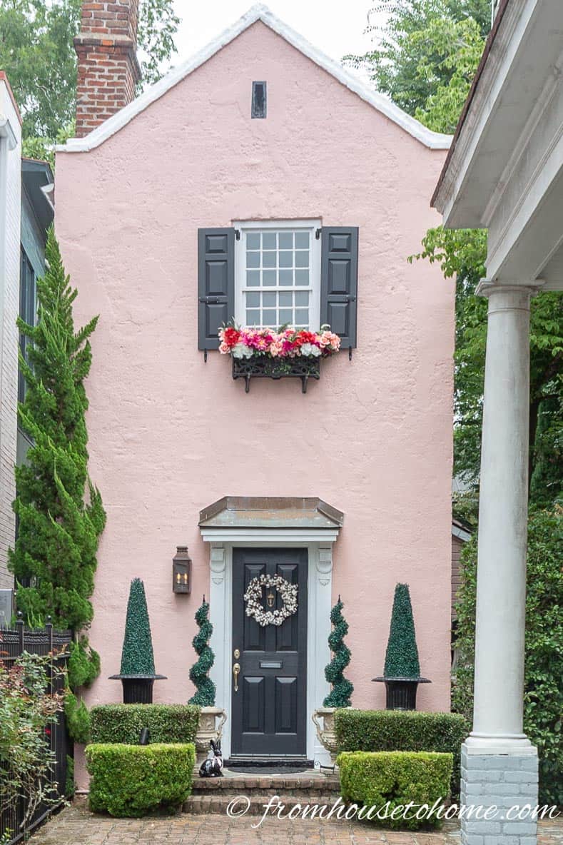 Pink house with artificial window box flowers in Charleston