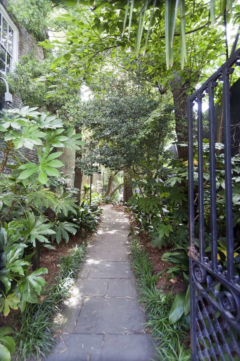 Gated alley entrance to secret garden with curved pathway. Charleston, South Carolina. ©Noel - stock.adobe.com