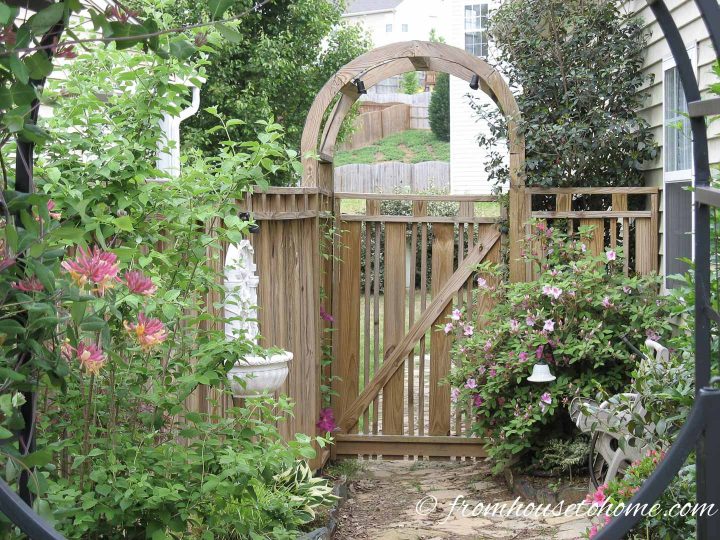 Custom wood privacy fence with a round arbor
