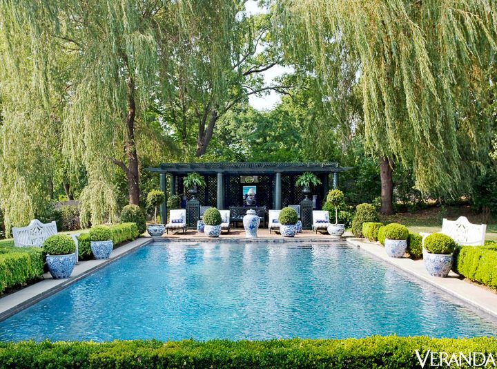 Blue and white ginger jars around a pool by Carolyne Roehm, via Veranda