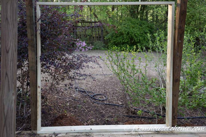 The outer frame for the DIY garden privacy screen standing up between the posts