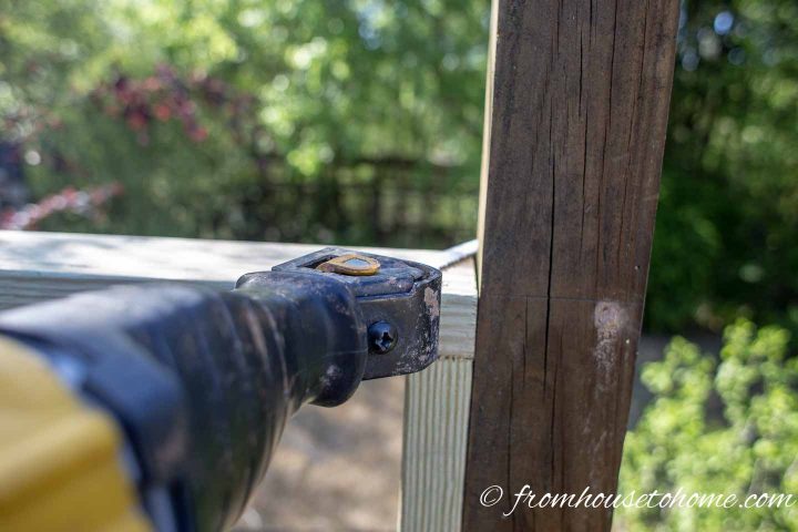 The top of the privacy screen post being cut off with a reciprocating saw