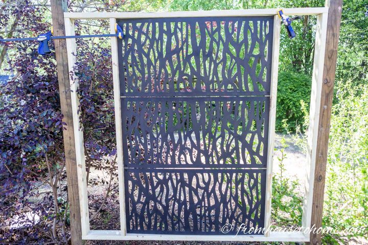 The decorative lattice panel clamped into the outer frame