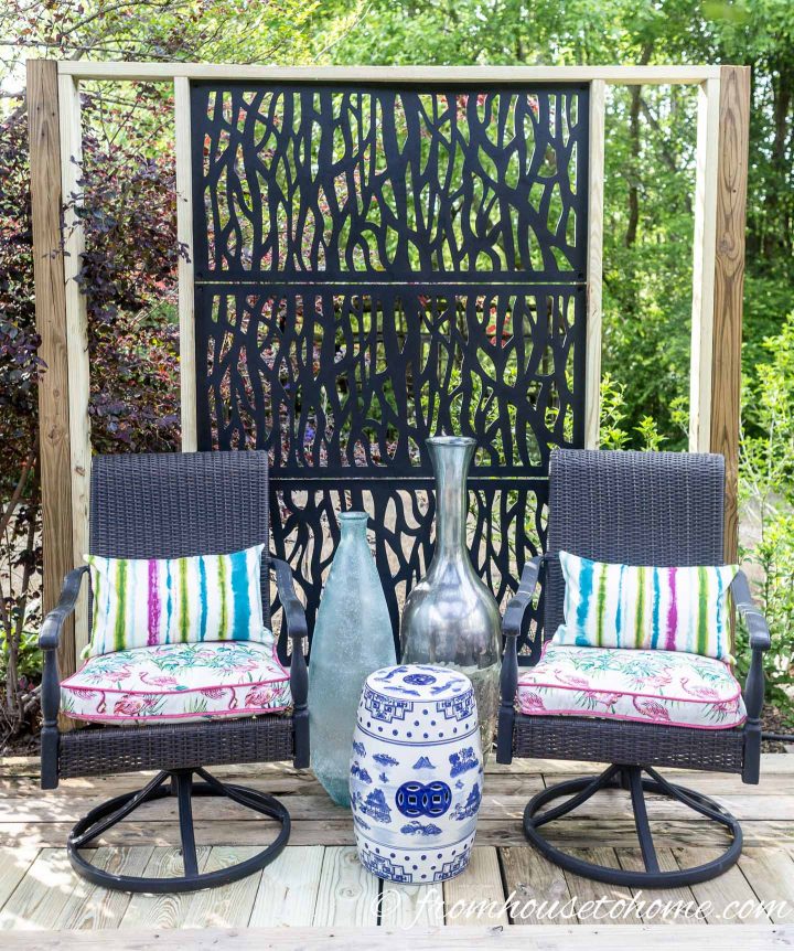 The deck privacy screen behind deck chairs
