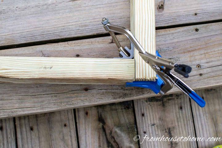A Kreg corner clamp holding 2" x 4" boards square