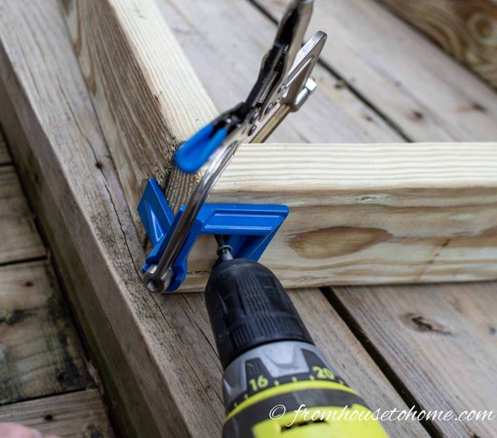 A screw being installed using a cordless drill and a Kreg corner clamp