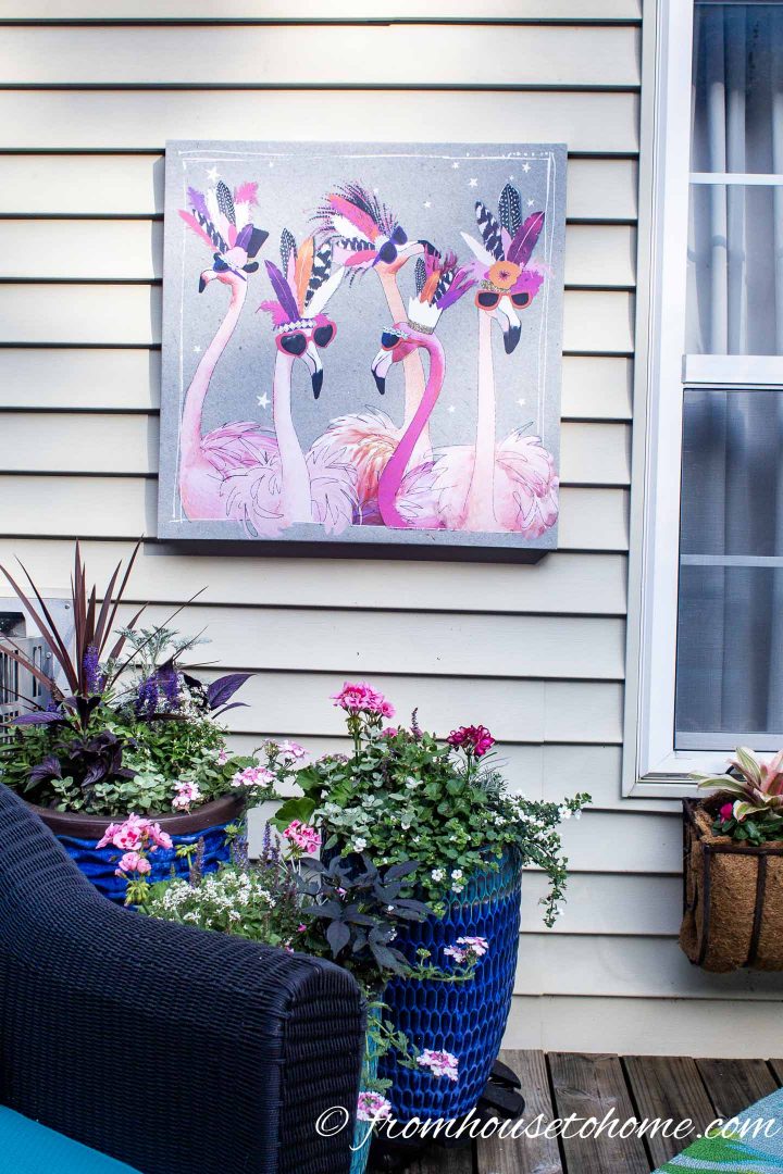 Inexpensive painting of flamingos hung on exterior house wall