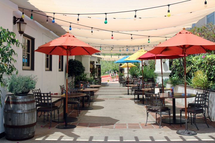 String lights with multi colored bulbs under pergola