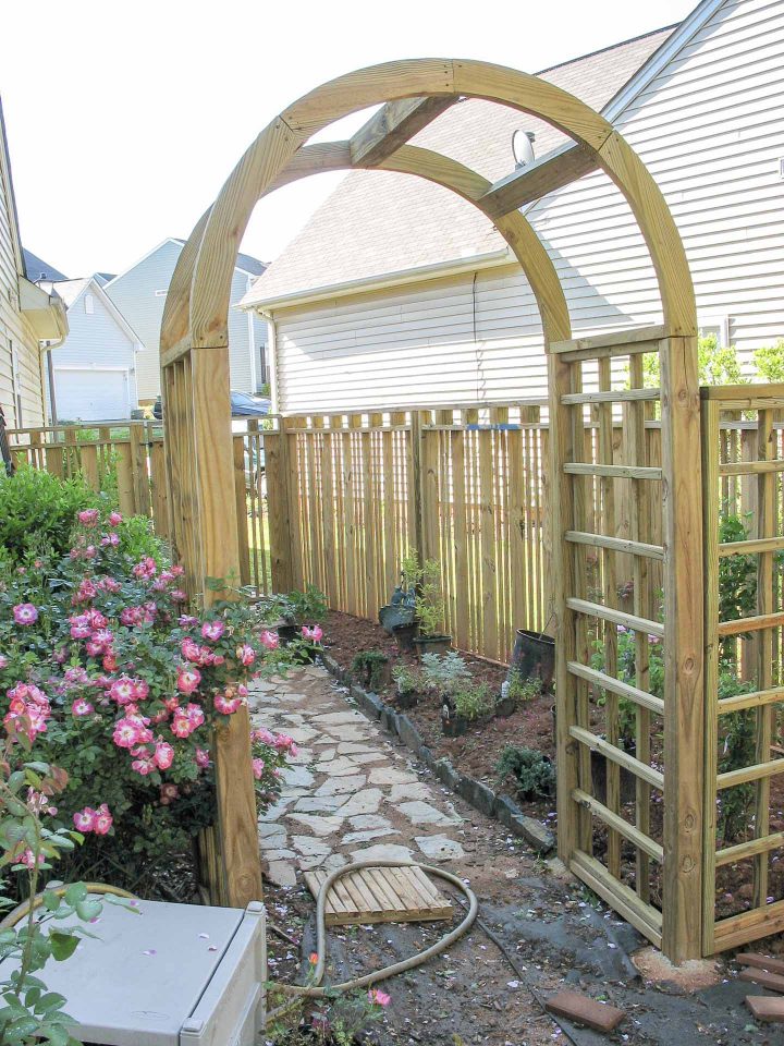 DIY custom wooden fence with an arbor