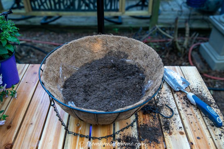 Hanging basket filled part way with potting soil