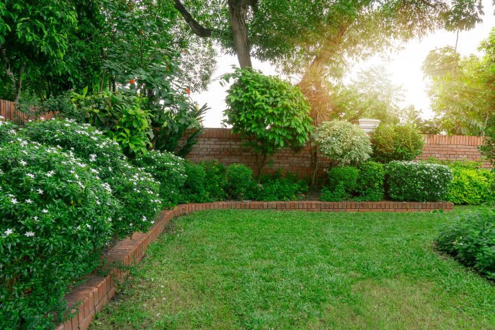 Stacked brick edging separating the lawn from the garden