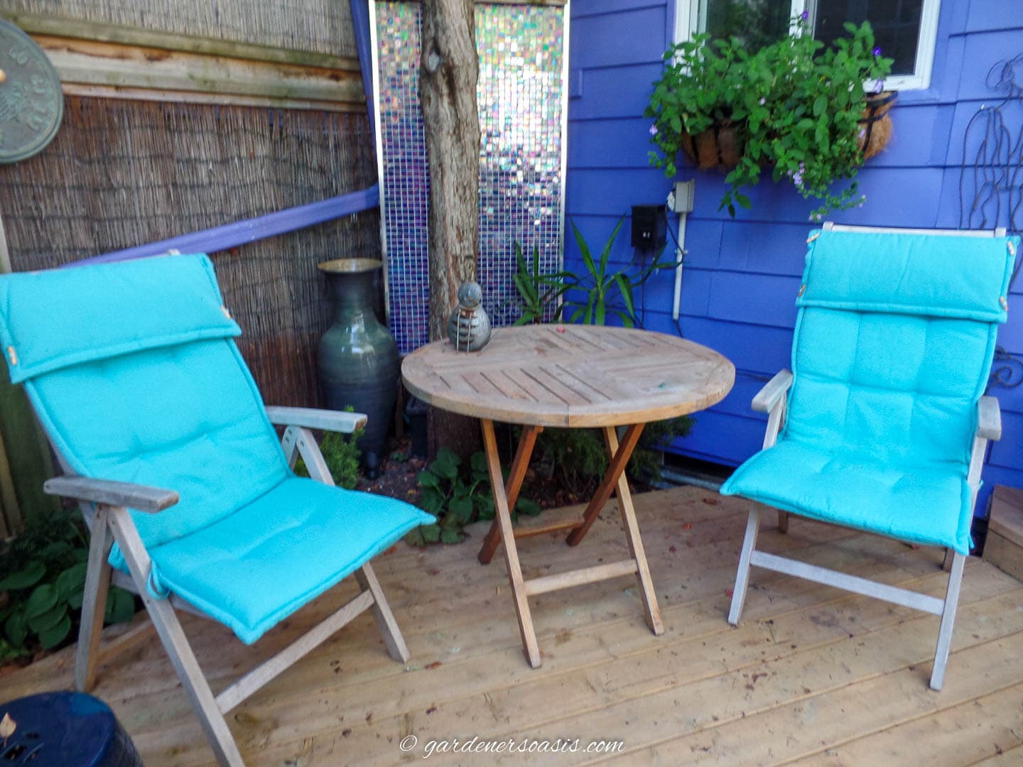 outdoor dining area on a zen deck in front of a wall water fountain