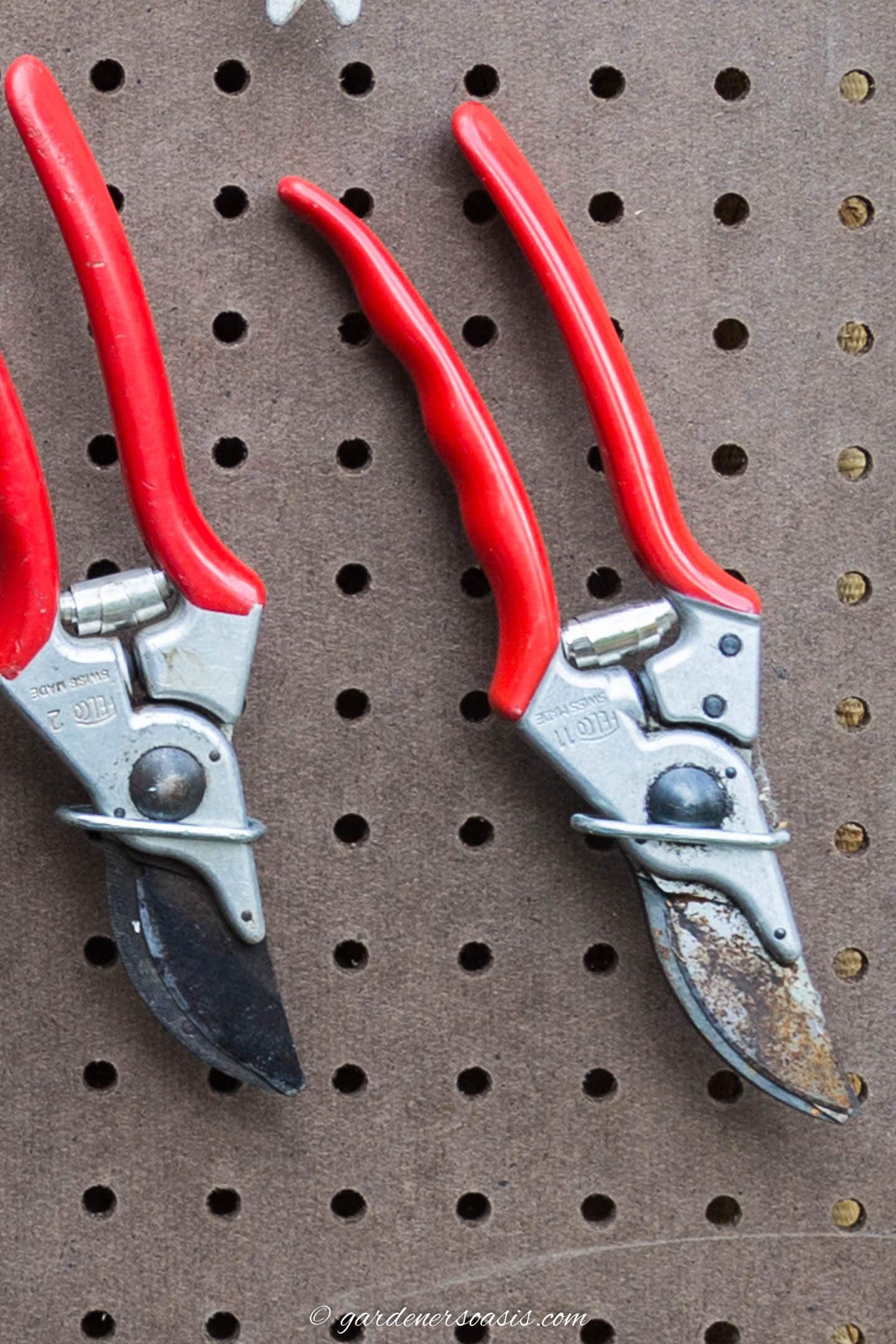 Garden pruners hung on pegboard with plier hooks