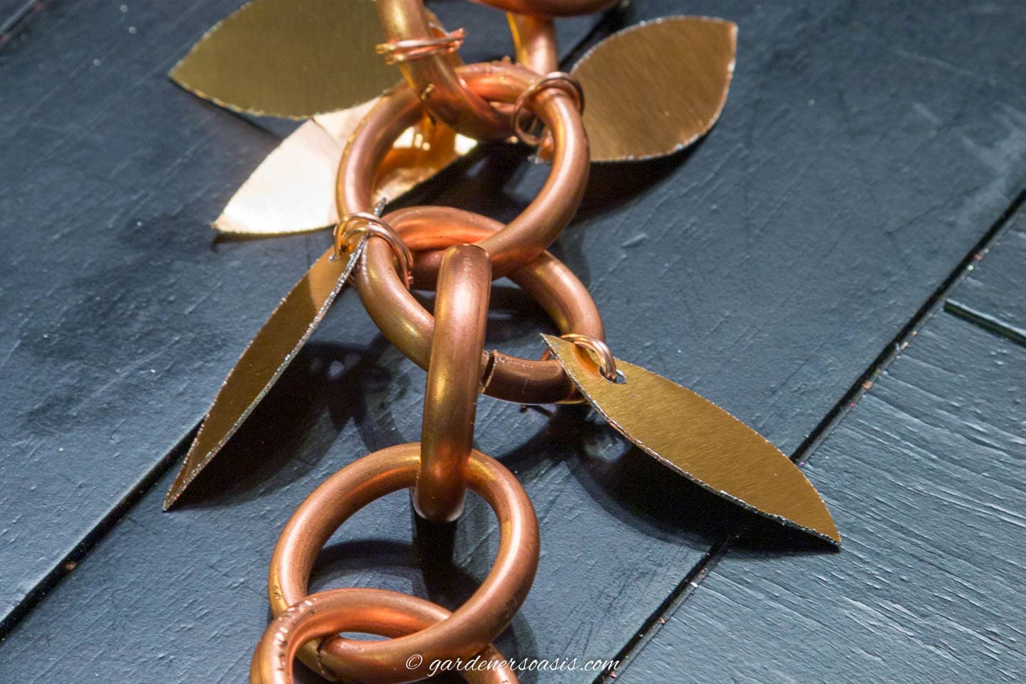 The rain chain with copper leaves attached to either side of it