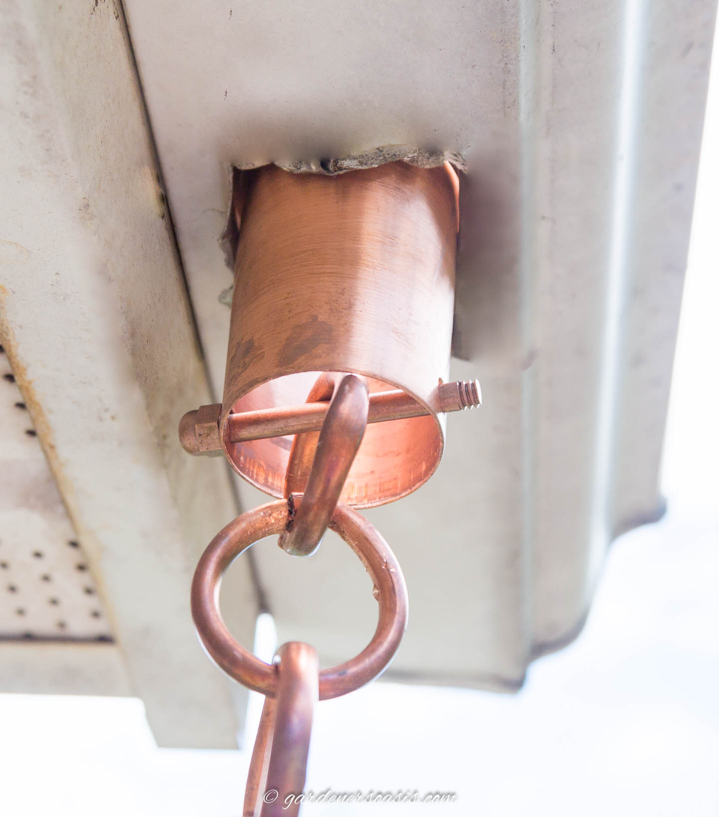Rani chain hung from the gutter with a rain chain installation kit