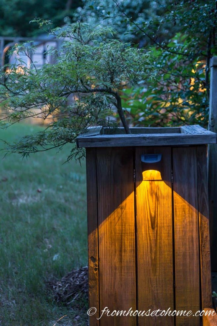 Install lights on the side of a planter around your deck