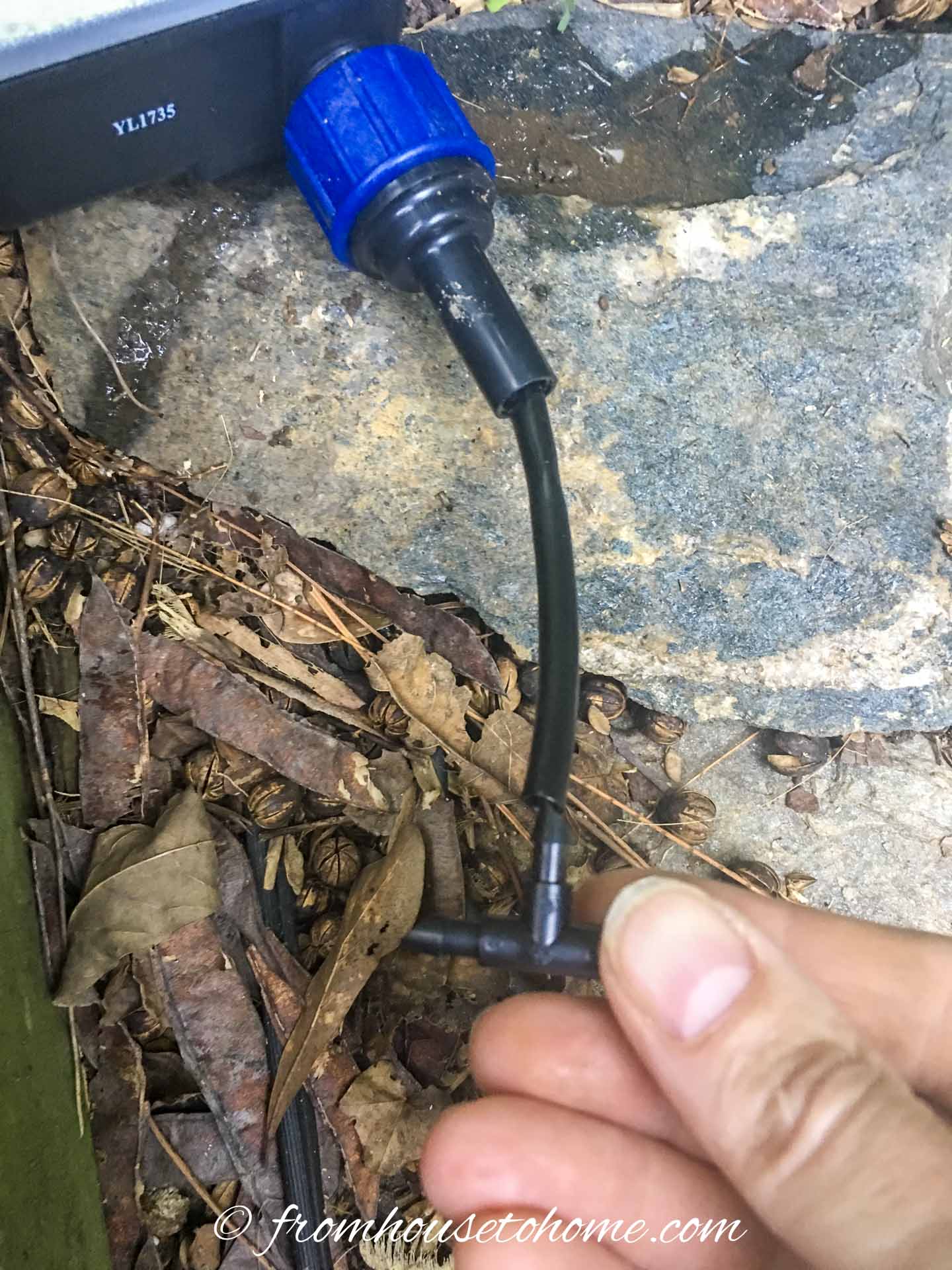 A splitter being attached to a container watering system hose