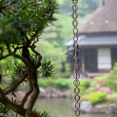 Rain chain with Japanese garden in the background