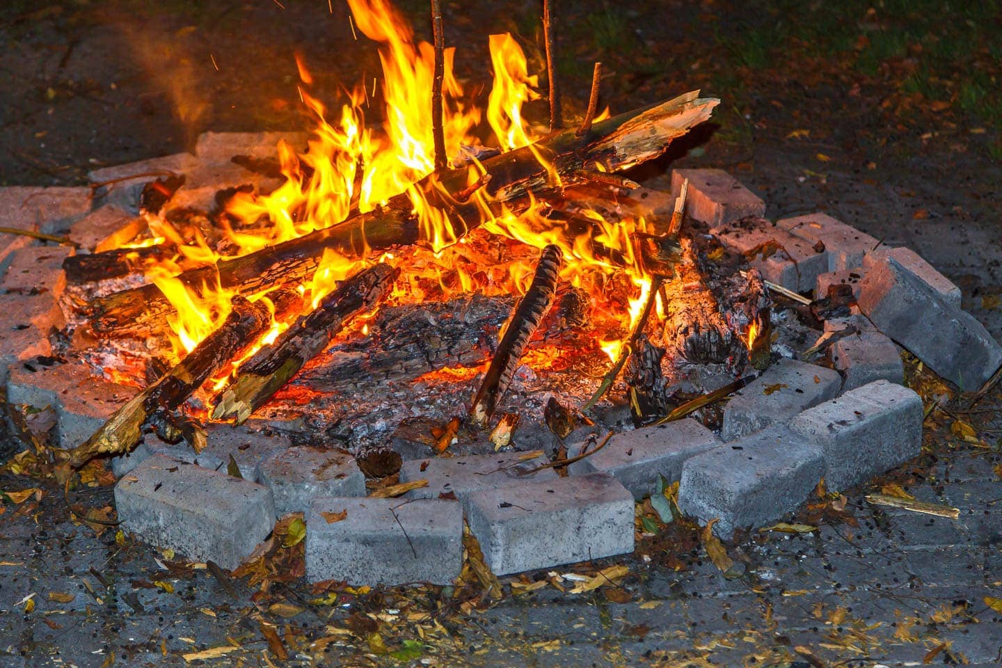 open air fire pit surrounded by two rows of cinder blocks