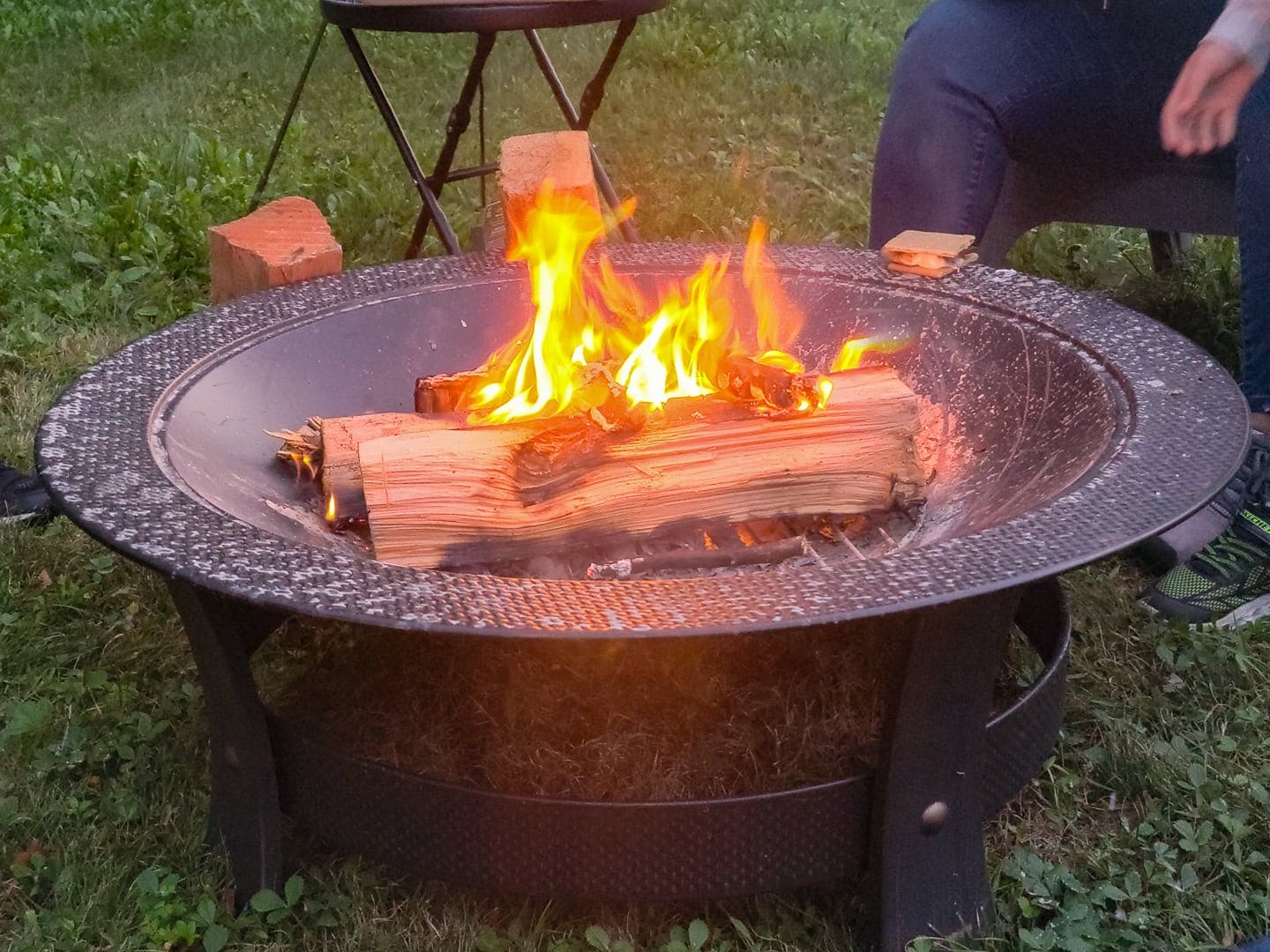 wood burning in a small metal fire pit