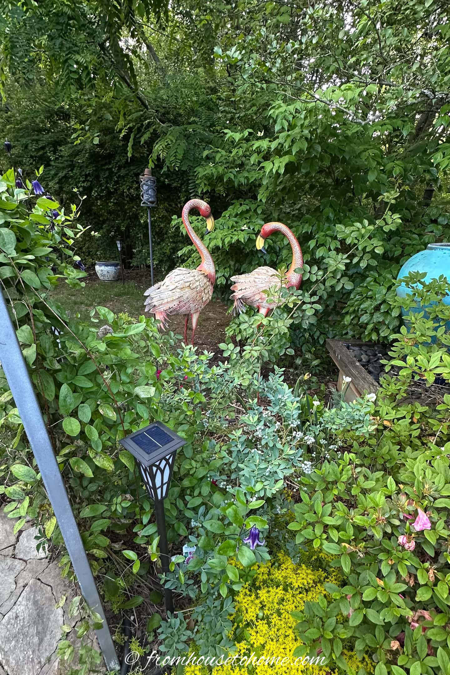 Two metal flamingoes in the garden