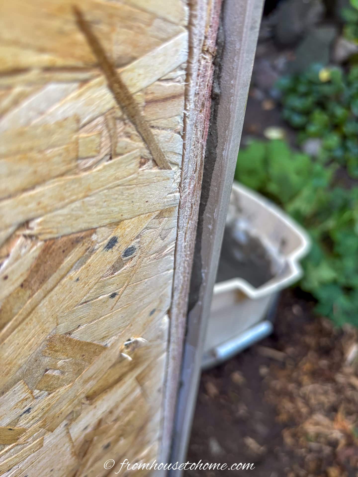 The tile extending past the edge of the wood plinth frame