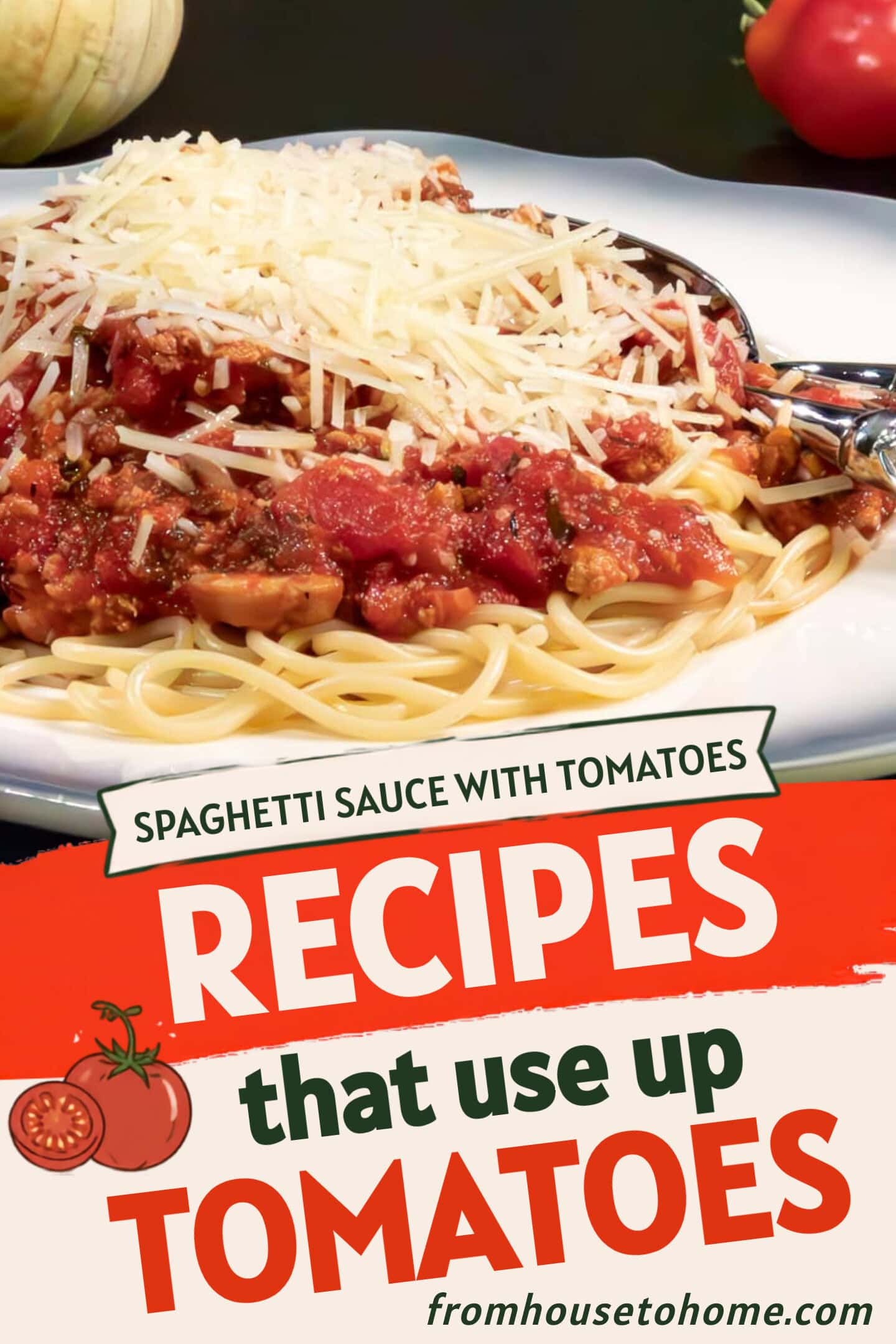 A plate of spaghetti topped with tomato meat sauce and grated cheese, with a fork and spoon on the side. Tomatoes and an onion are in the background.