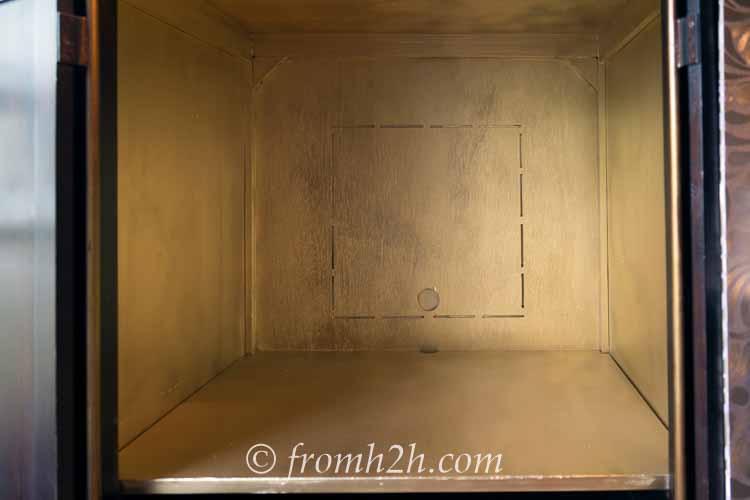 The inside of the armoire painted gold