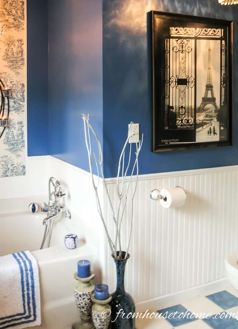 Bathroom wall with white wainscotting and dark blue paint