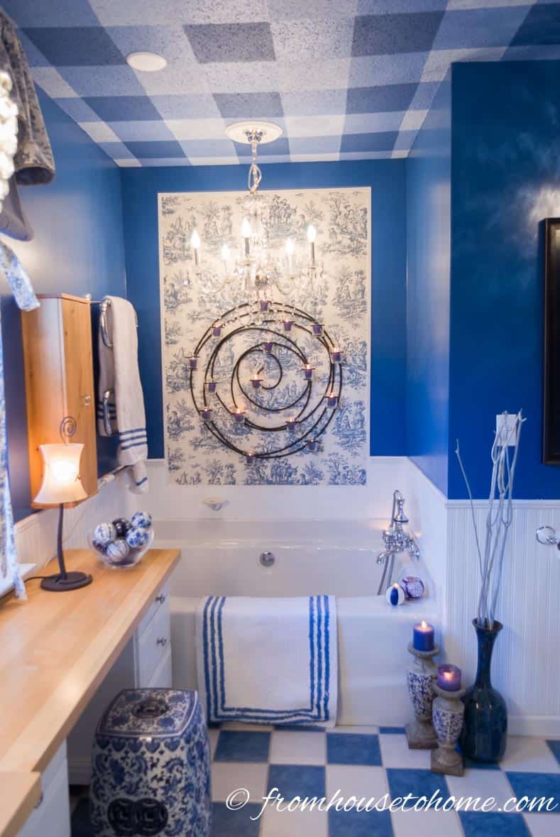 Blue and white bathroom with toile insert above the tub