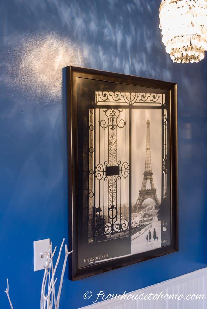 A black and white Paris picture hanging on a blue wall