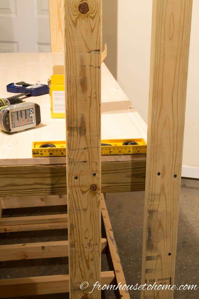 Attach shelf legs to the workbench | How To Build a Fold Down Workbench in a Day