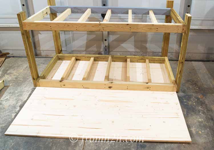 Lay down the other half of the top so that it is pushed right up against the workbench top | How To Build a Fold Down Workbench in a Day