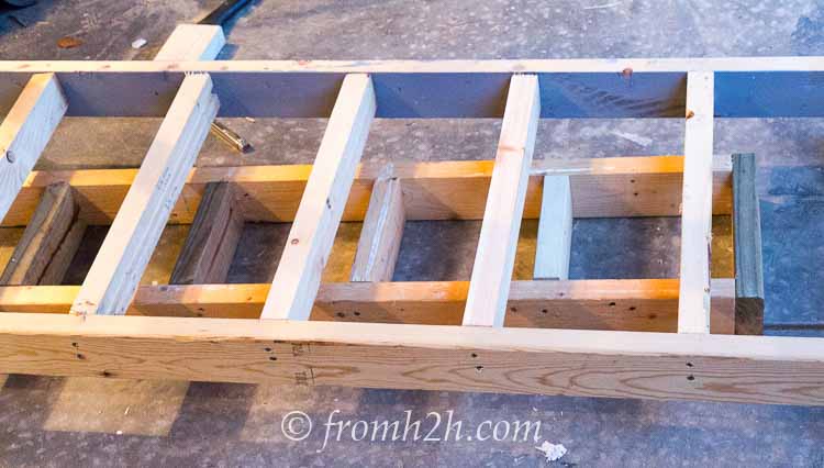 Use the top shelf as a spacer for installing bottom shelf | How To Build a Fold Down Workbench in a Day