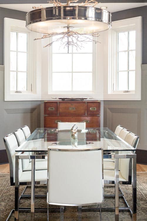 Small dining room with a glass dining table - Photo by In Site Designs