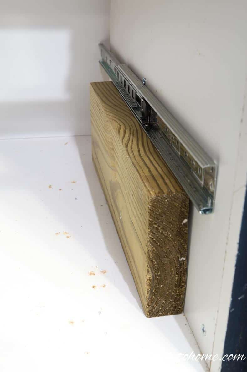 Install the bottom drawer slide in the cabinet