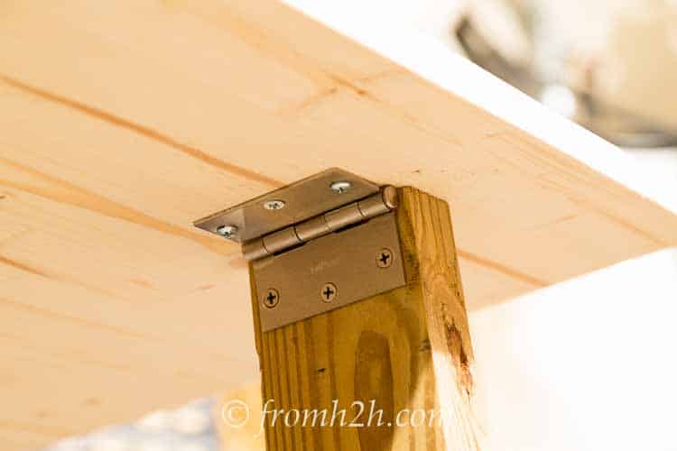 Position the leg under the fold down top and attach the other side of the hinge | How To Build a Fold Down Workbench in a Day
