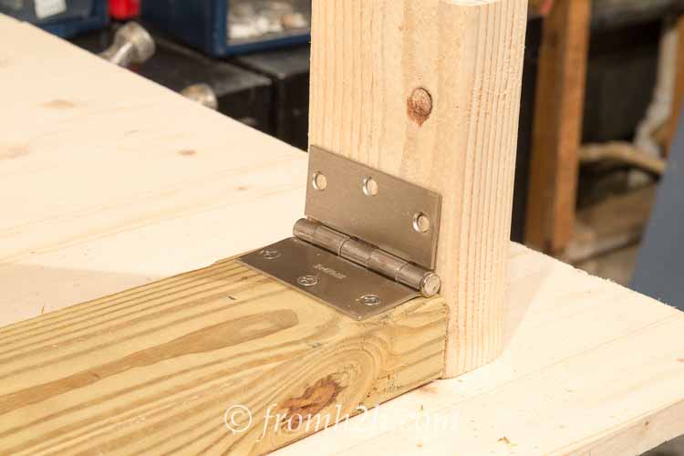 Attach the hinge to the top of the leg, using another board to make sure it is in the right location | How To Build a Fold Down Workbench in a Day