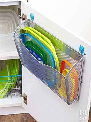 Wall-mount magazine file storing plastic container lids on the back of a kitchen cabinet door