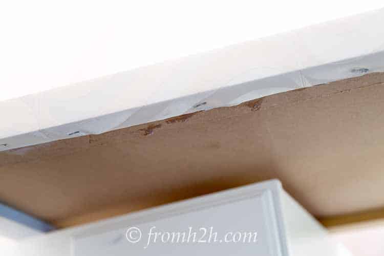 Hammer in the staples if they are not flush | How To Update A Countertop Without Spending A Lot Of Money