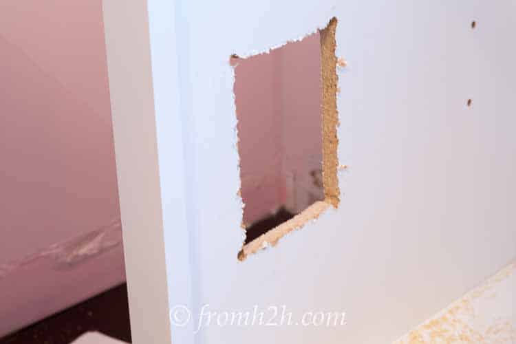 The hole for the electrical outlet | How To Create Built Ins From Mismatched Furniture